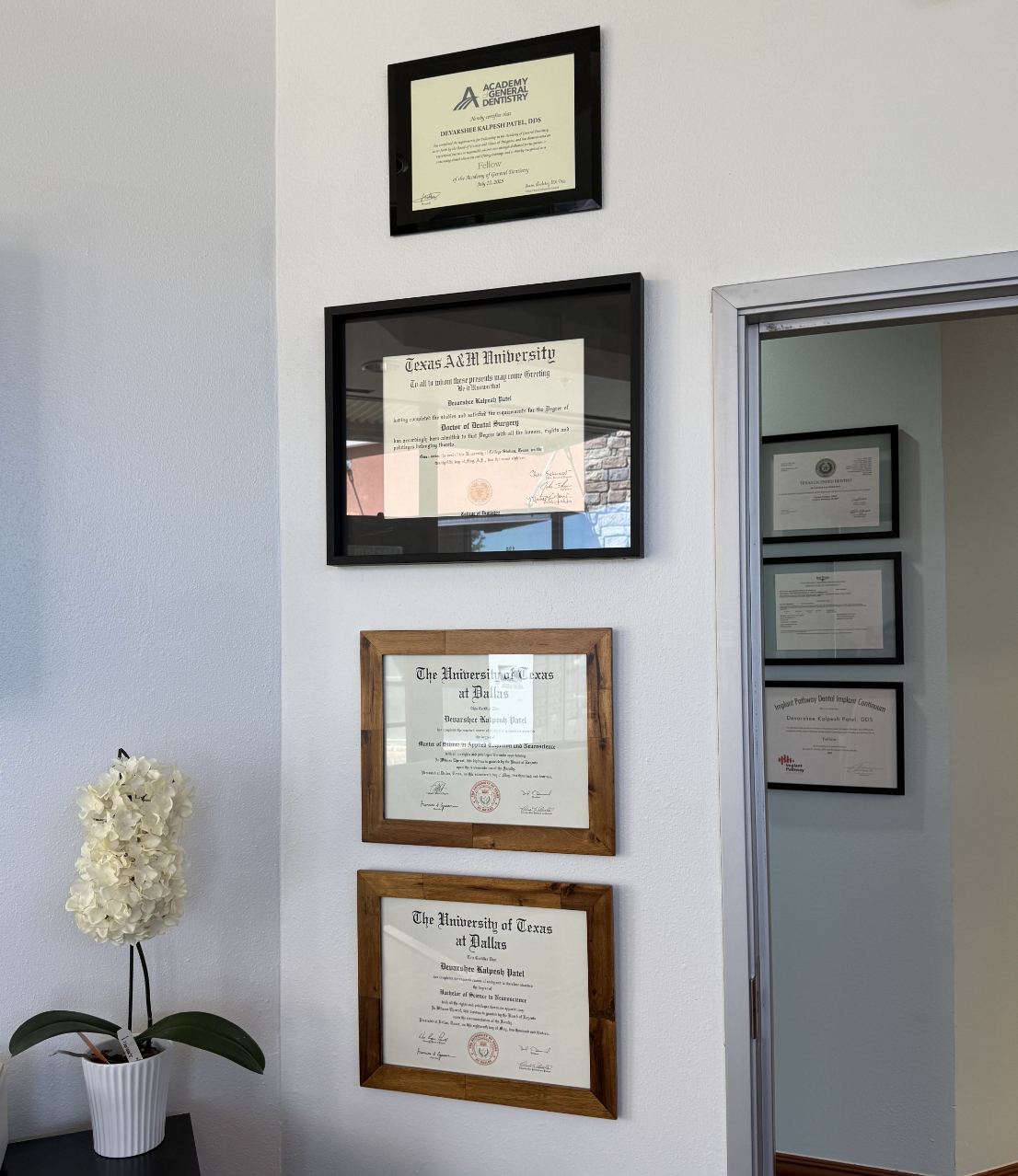 Doctor Patel's diplomas and certificates framed on a wall