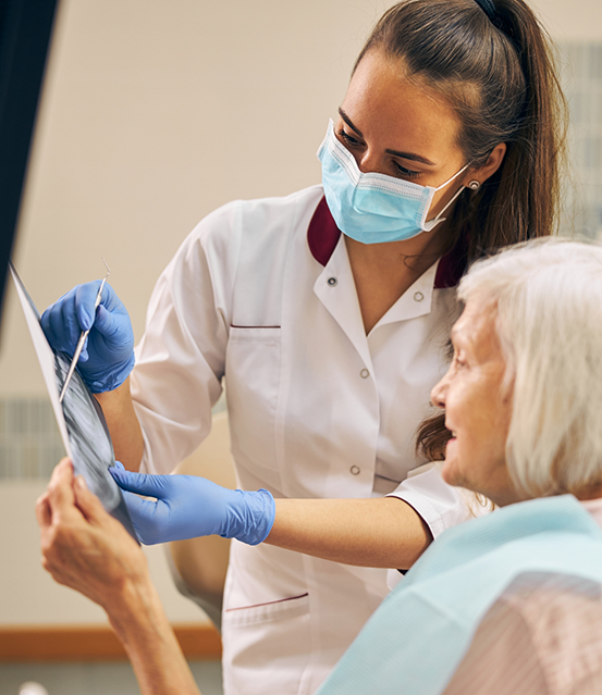 Dentist showing a patient an x ray of their teeth