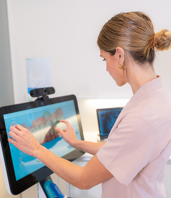 Dentist looking at digital impressions of a patient's teeth