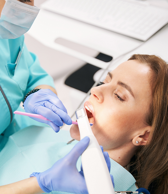 Dentist taking close up photos of a patient's teeth