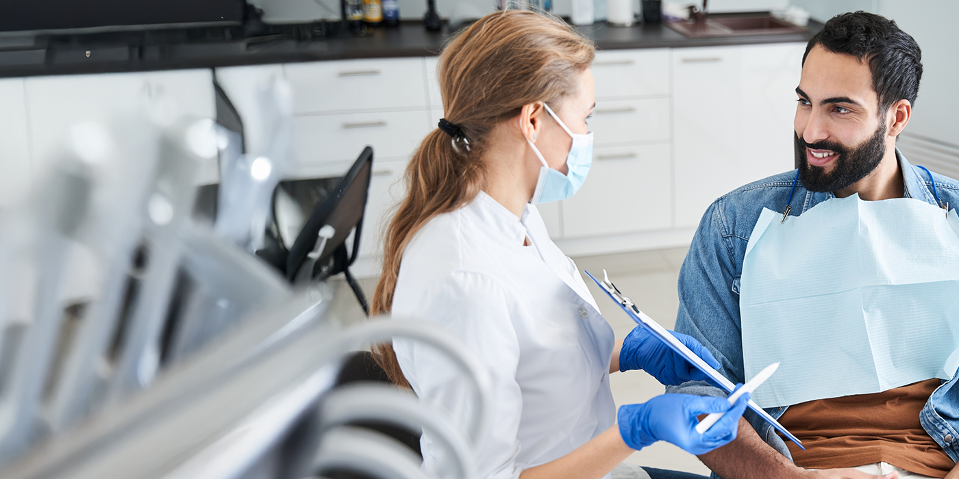 Man talking to his dentist about bad breath treatment in Fort Worth