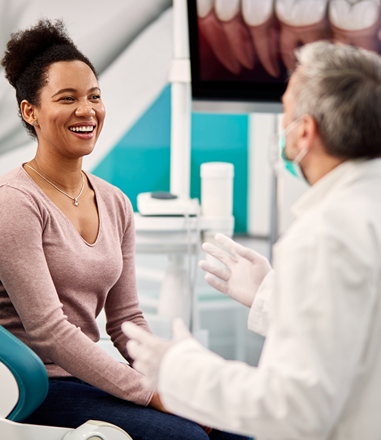 Woman smiling at her dentist