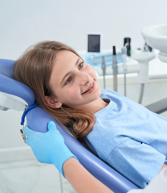 Girl leaning back in the dental chair