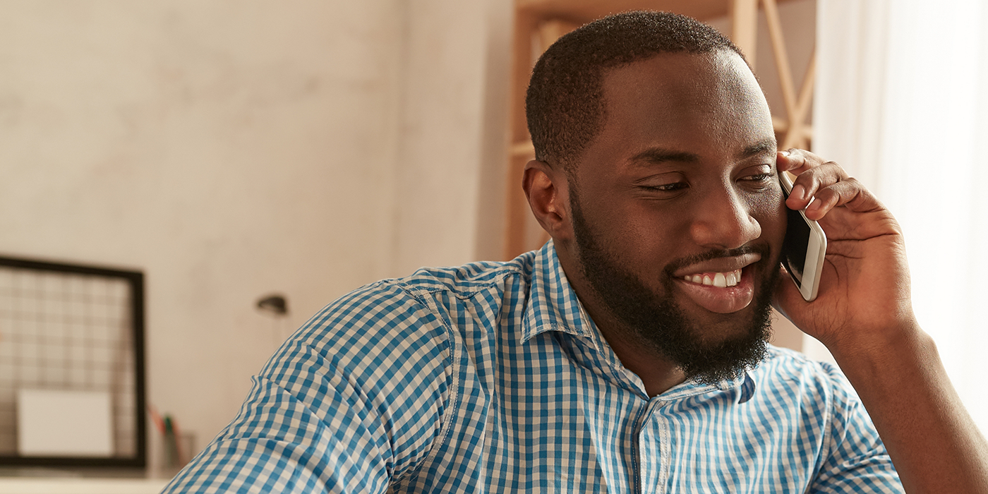 Man talking on the phone with a dental office in Fort Worth