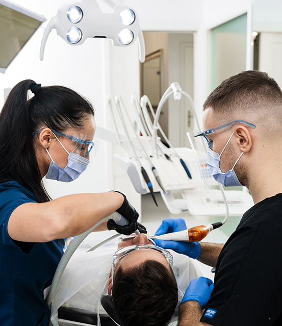 Dentist and assistant treating a patient