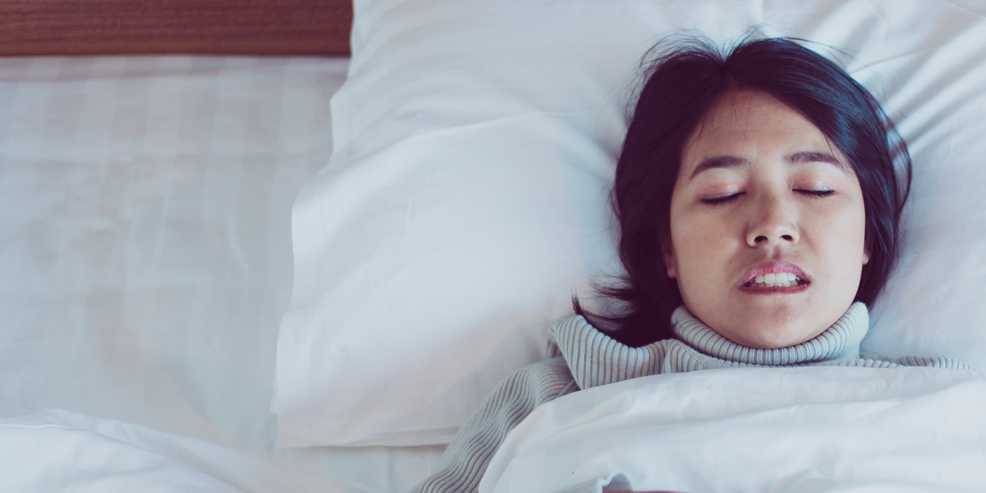 Woman clenching her teeth while sleeping