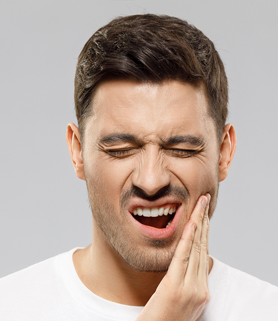 Man holding the side of his face in pain