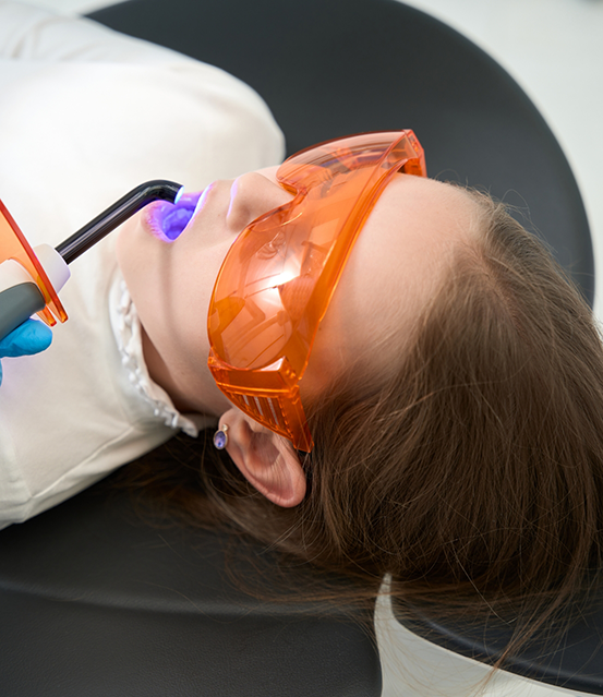 Child dental patient receiving sealants