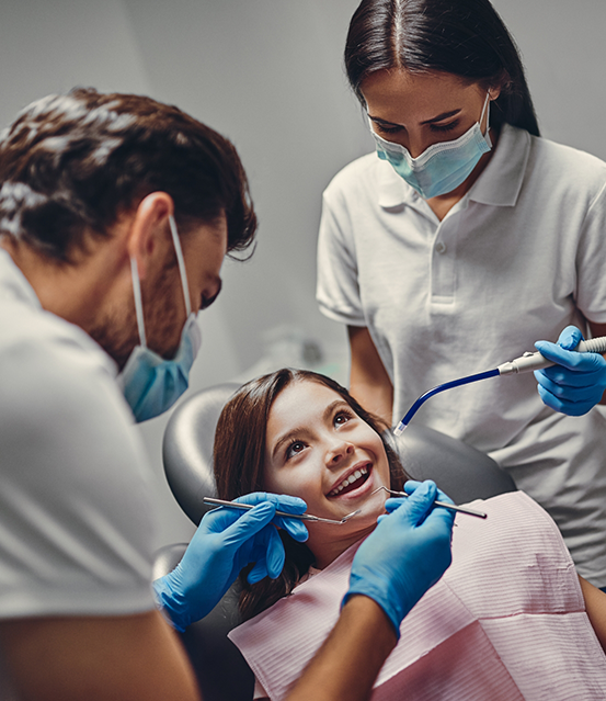 Young girl receiving a dental treatment