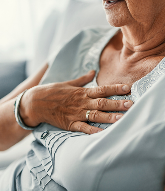 Older woman clutching her chest
