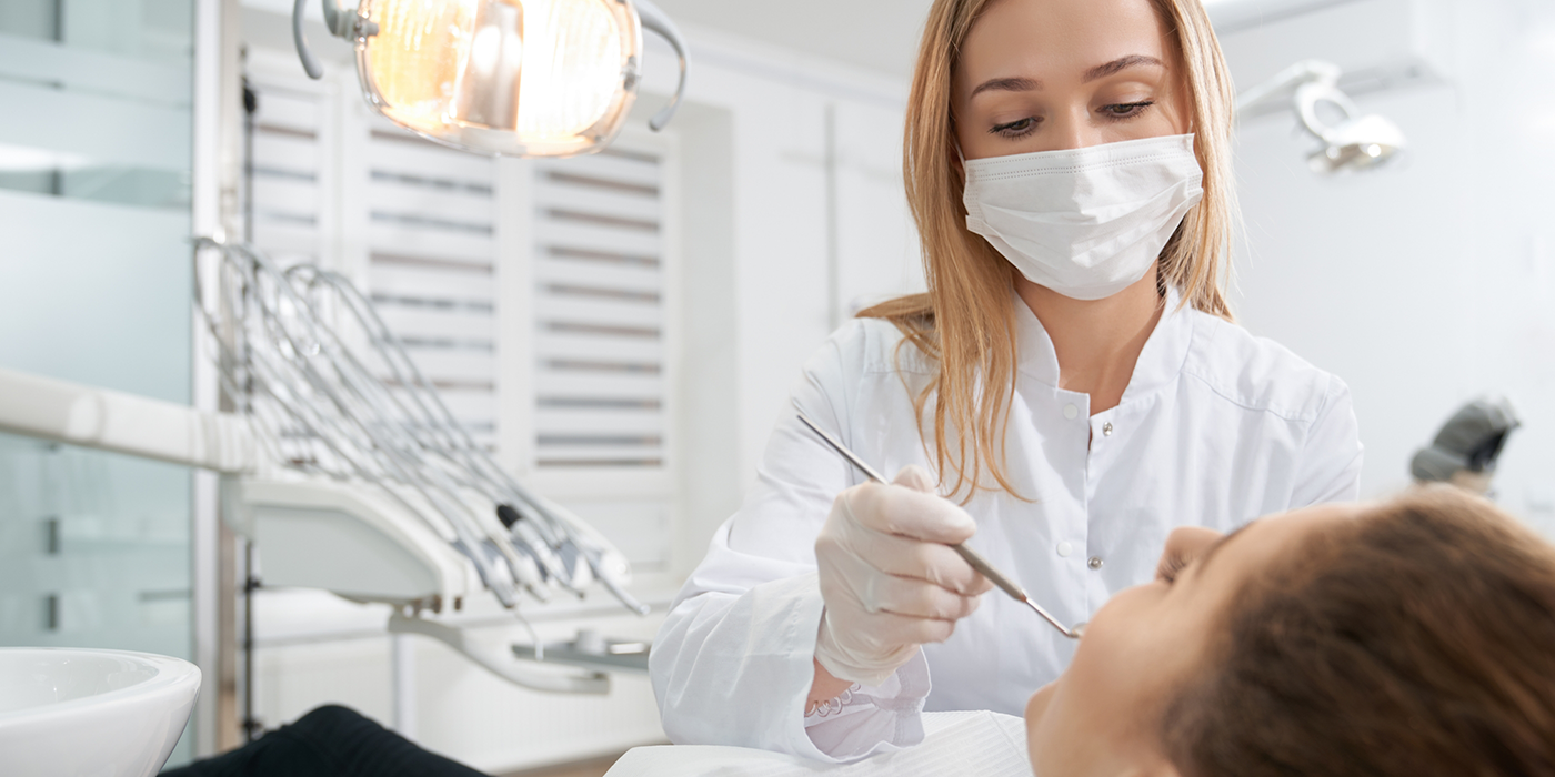 Dentist giving a patient a preventive dental exam