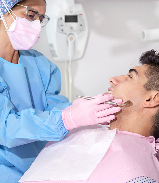 Young man grinning at his dentist during a checkup