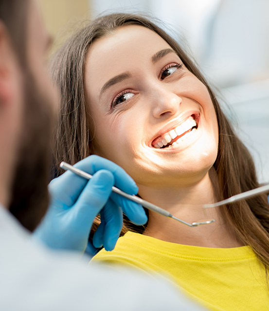 Woman smiling at her dentist during a checkup