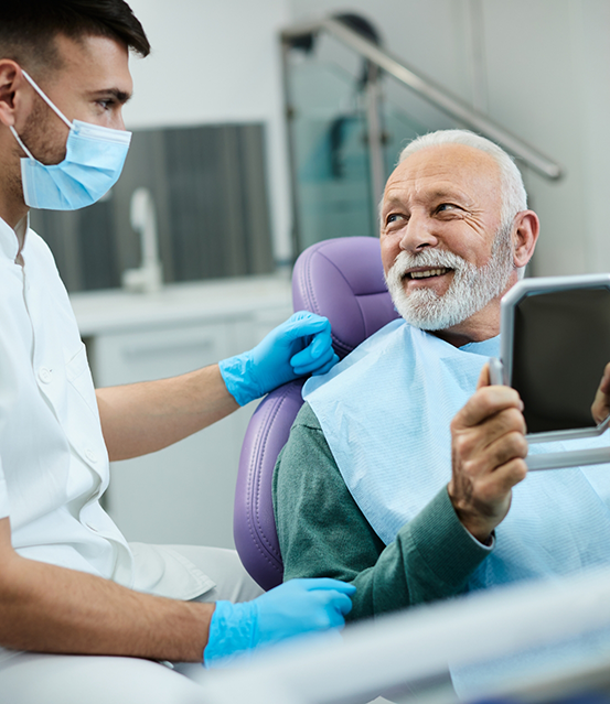Senior man smiling with his dentist