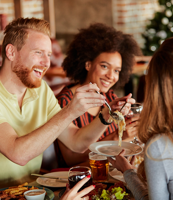 Group of adults enjoying a meal at a restaurant