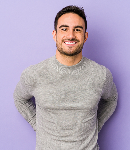 Smiling man in a gray sweater