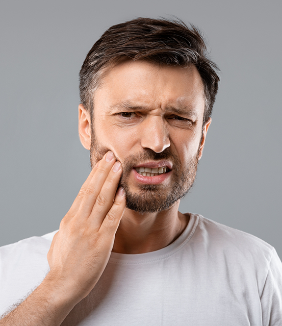 Man holding the side of his face in pain
