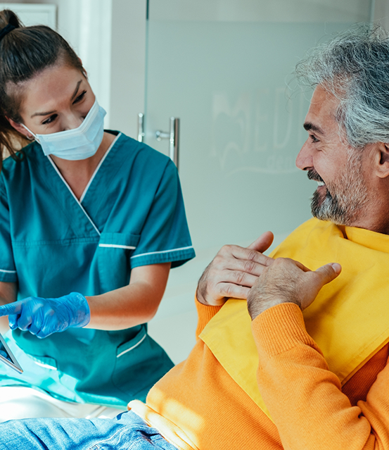 Older man talking to his dentist