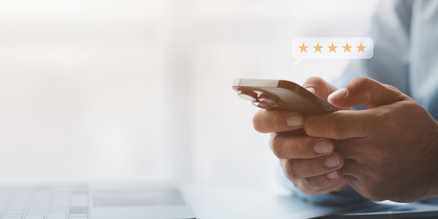 Person leaving a five star review on their phone