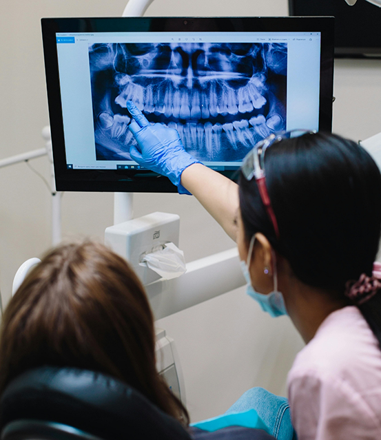 Dentist showing a patient an x ray of their teeth
