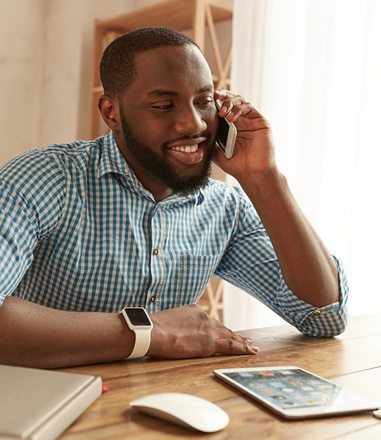 Man smiling while talking on the phone