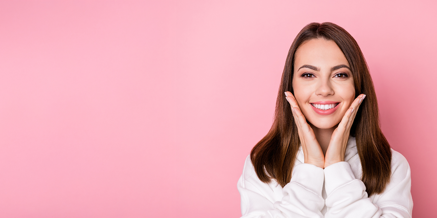 Woman smiling brightly after teeth whitening in Fort Worth