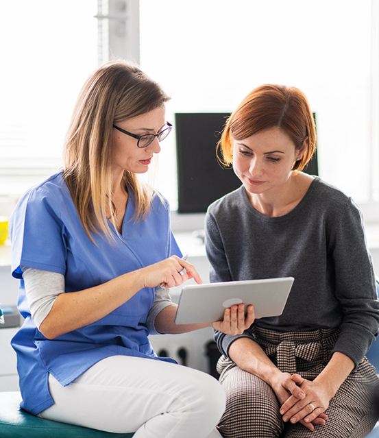 Dentist showing a tablet to a patient