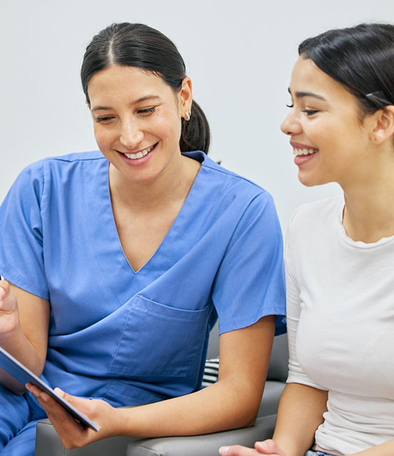 Dentist showing a patient a tablet