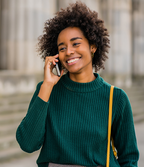 Person smiling while talking on the phone